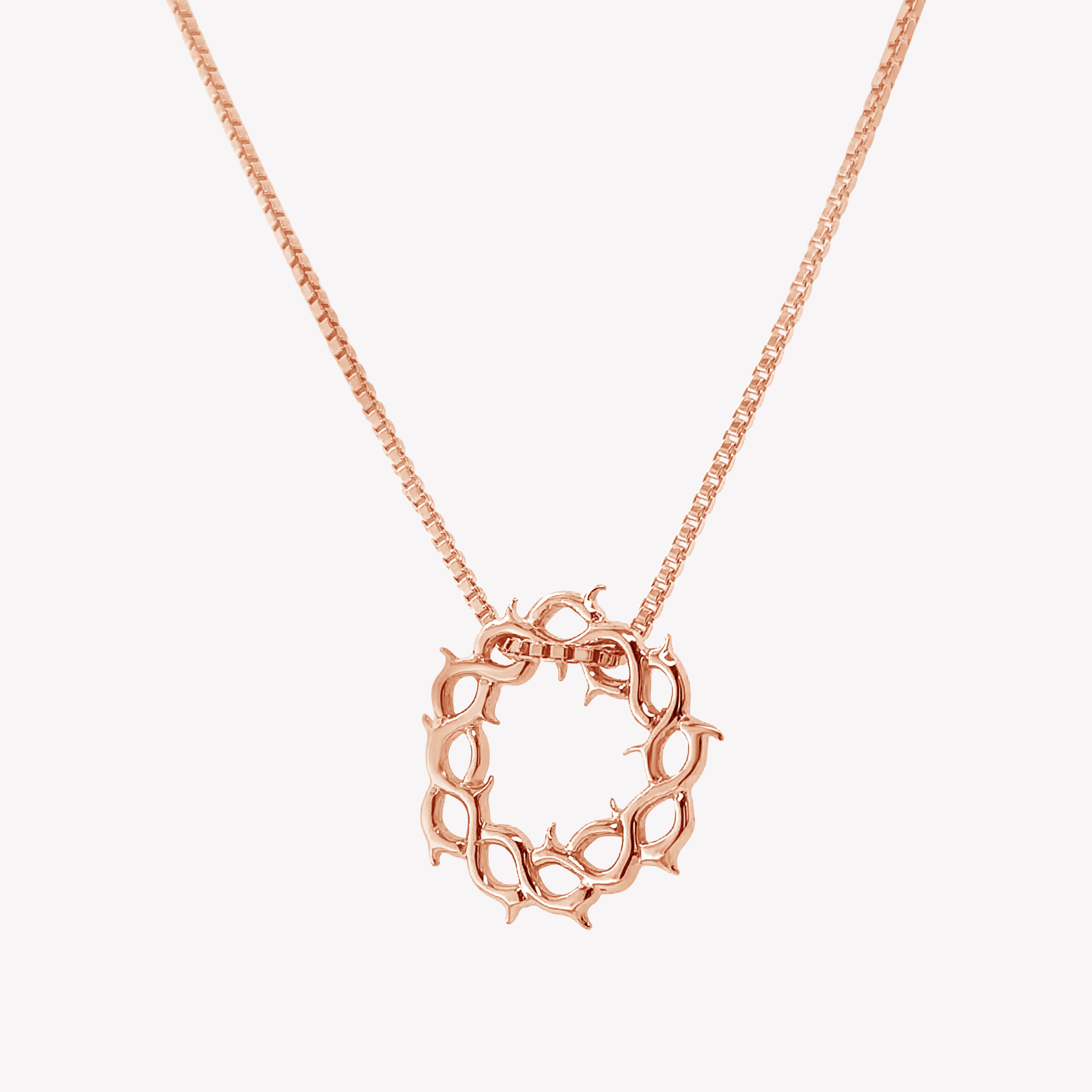Rose gold vermeil Crown of Thorns Necklace by Rizen Jewelry. Box chain threaded through faith inspired crown of thorns pendant with Cross Tag.