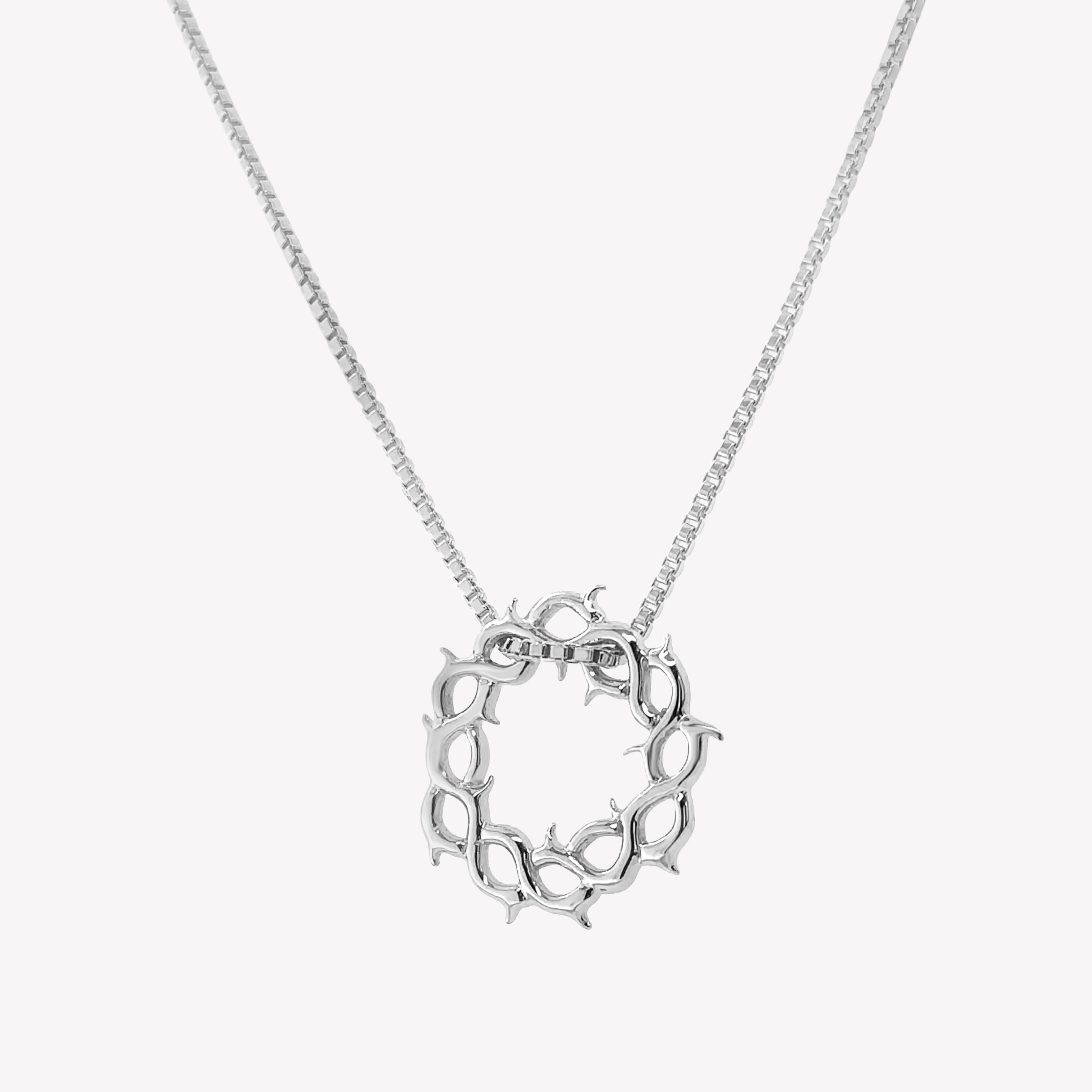 Sterling silver Crown of Thorns Necklace by Rizen Jewelry. Box chain is threaded through faith inspired pendant. 