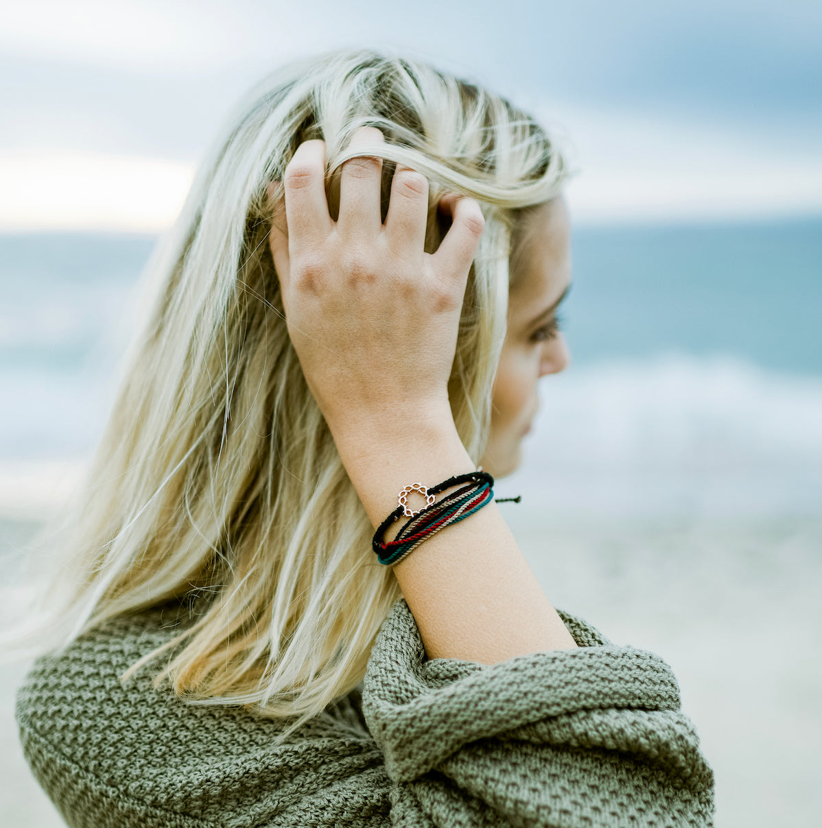 Rizen Jewelry Model wearing Made 4 Ministries Faithful Bracelet Jewelry Set containing Black Crown of Thorns Cord bracelet and the faithful black, garnet red, azure blue, khaki Be Magnified multi cord bracelet. 